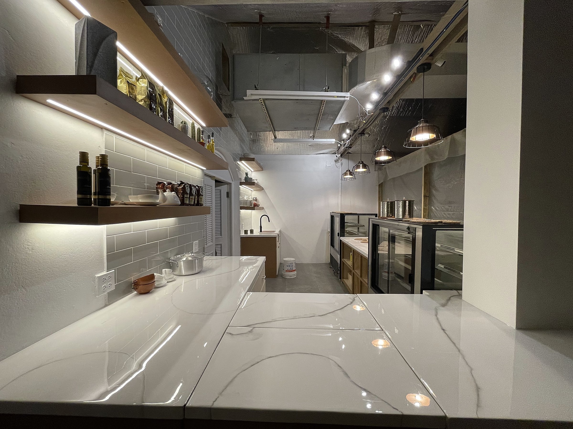 Covent Garden Deli — completed interior, polished counter surface and under-shelf lighting