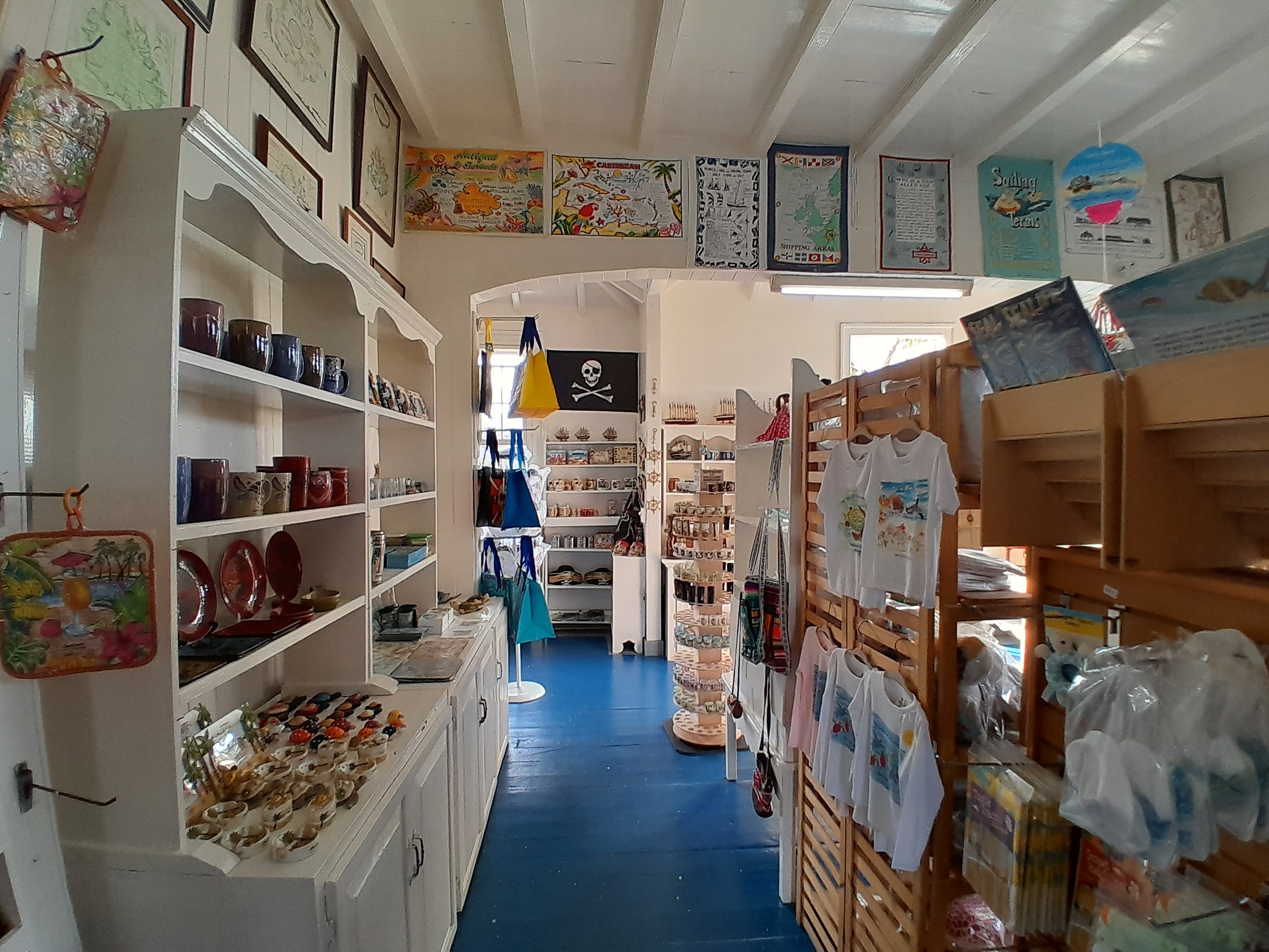 Nelson's Dockyard Gift Shop — existing interior prior to renovation, showing dense retail fixtures and crowded wall displays