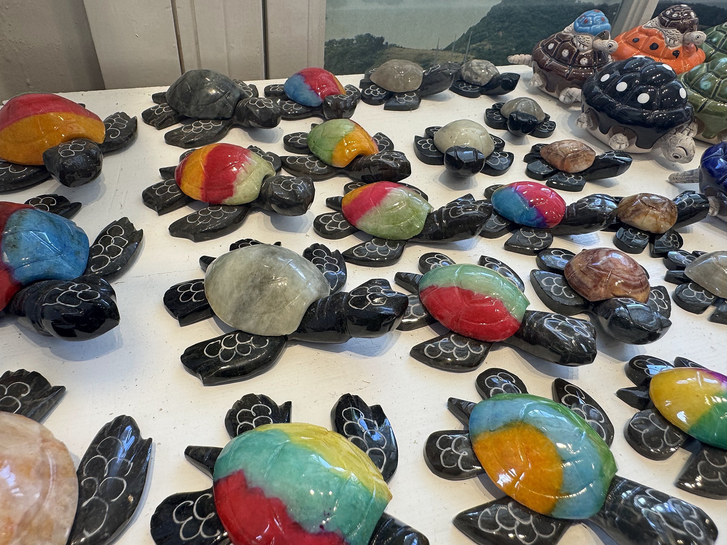 Nelson's Dockyard Gift Shop — detail of hand-painted local craft pieces displayed on the counter