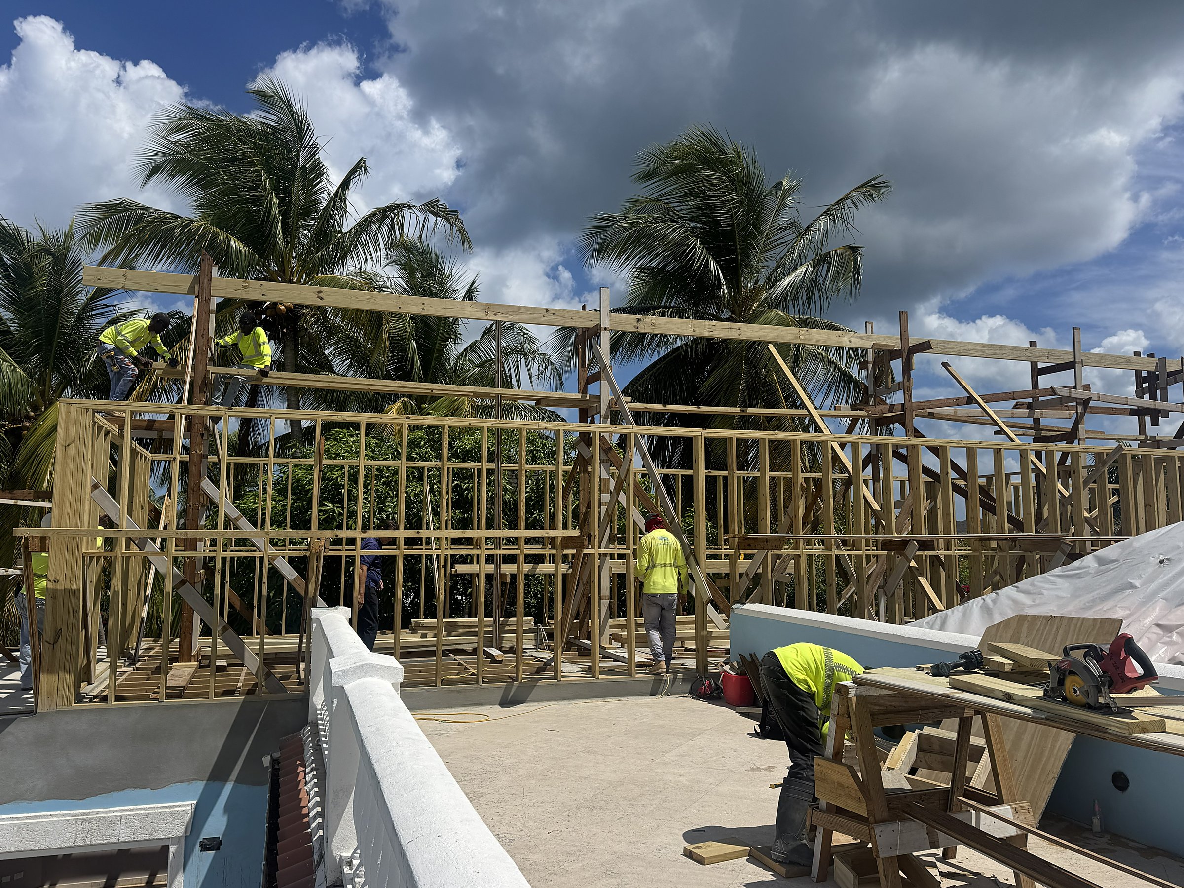 Jolly Harbour Residence — timber stud walls framed on the new second level, workers on site