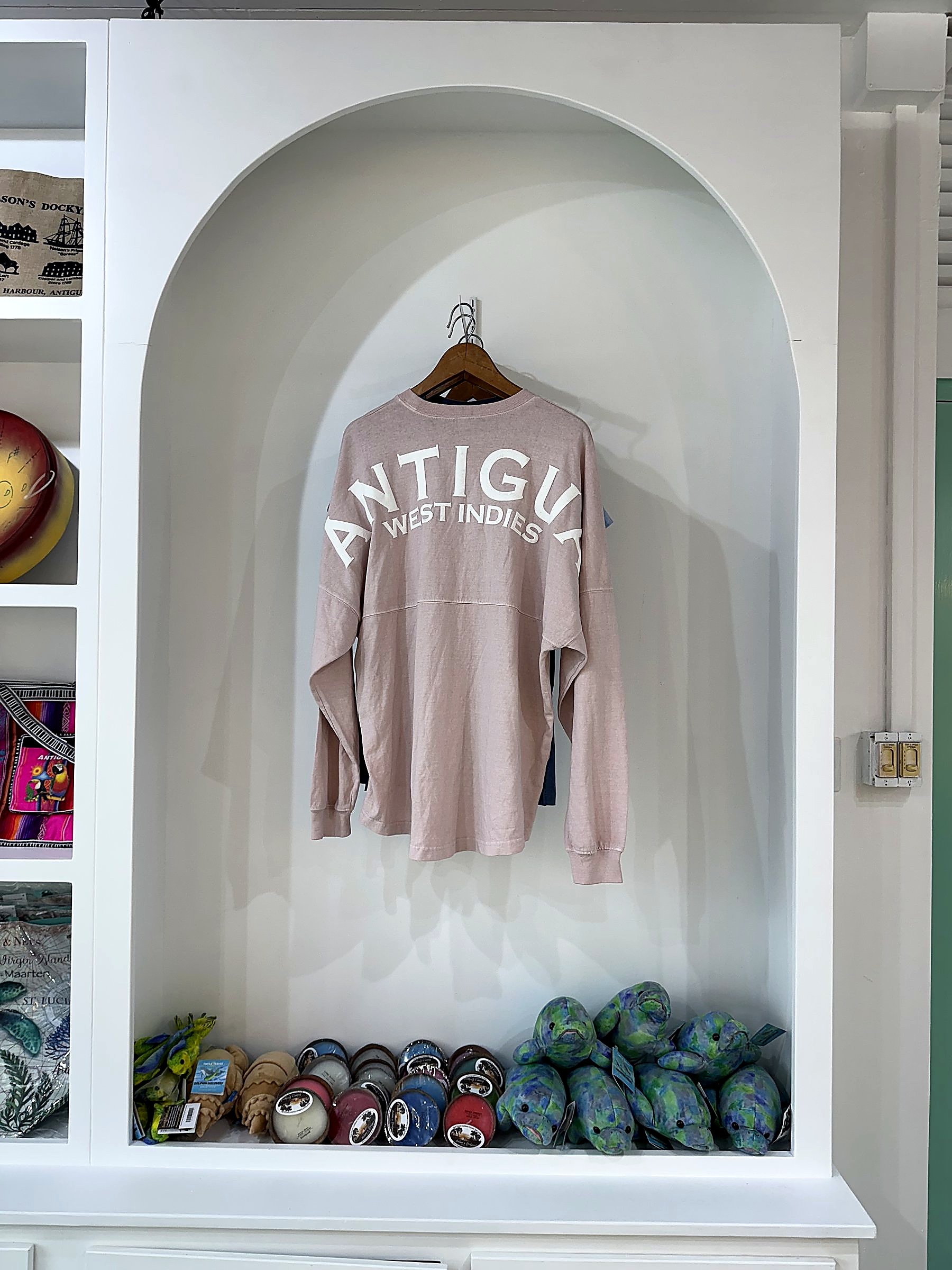 Interpretation Centre Gift Shop at Dow's Hill — a single arched niche styled for apparel, with folded goods and plush merchandise below