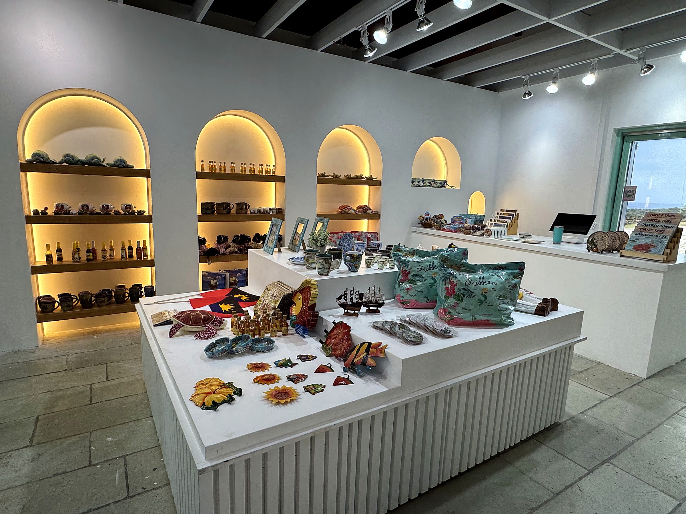 Interpretation Centre Gift Shop at Dow's Hill — full interior view showing illuminated arched niches, curated merchandise display, and central millwork counter