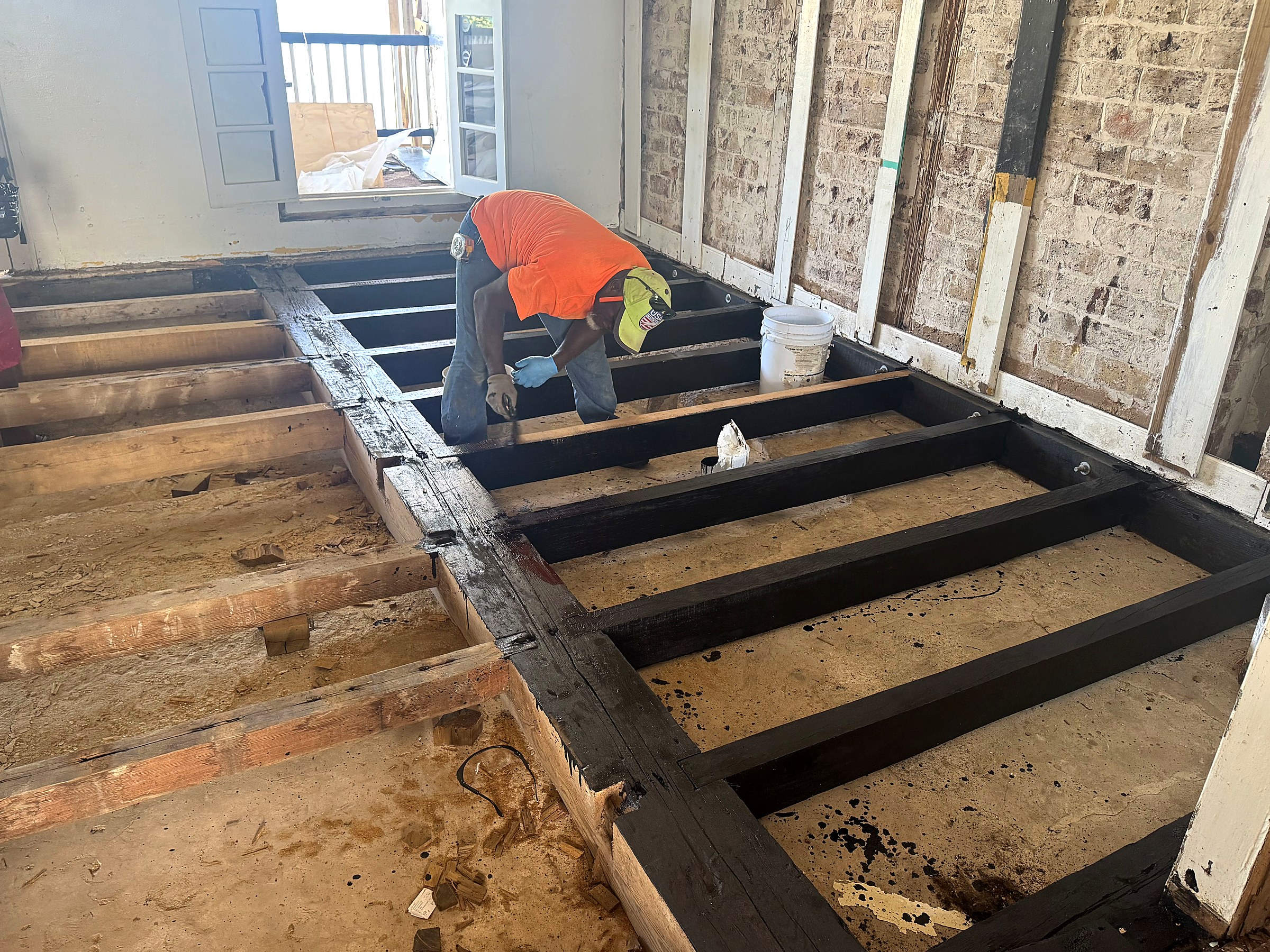 Officers' Quarters interior — replacement floor joists installed and treated ahead of new flooring